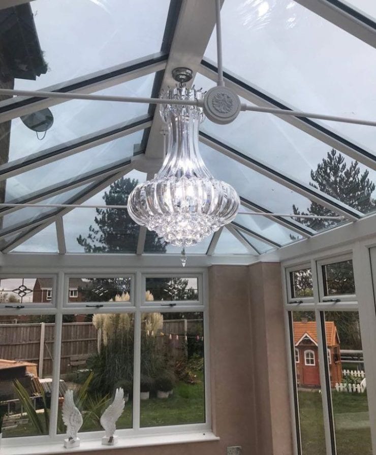 Interior view of conservatory with chandelier by Allerton Windows.