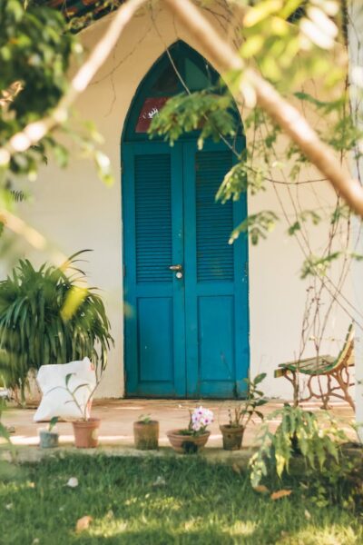 A blue door with bench seating for front door ideas. Photo by Alison Ferreira: https://www.pexels.com/photo/closed-blue-wooden-doors-2335490/